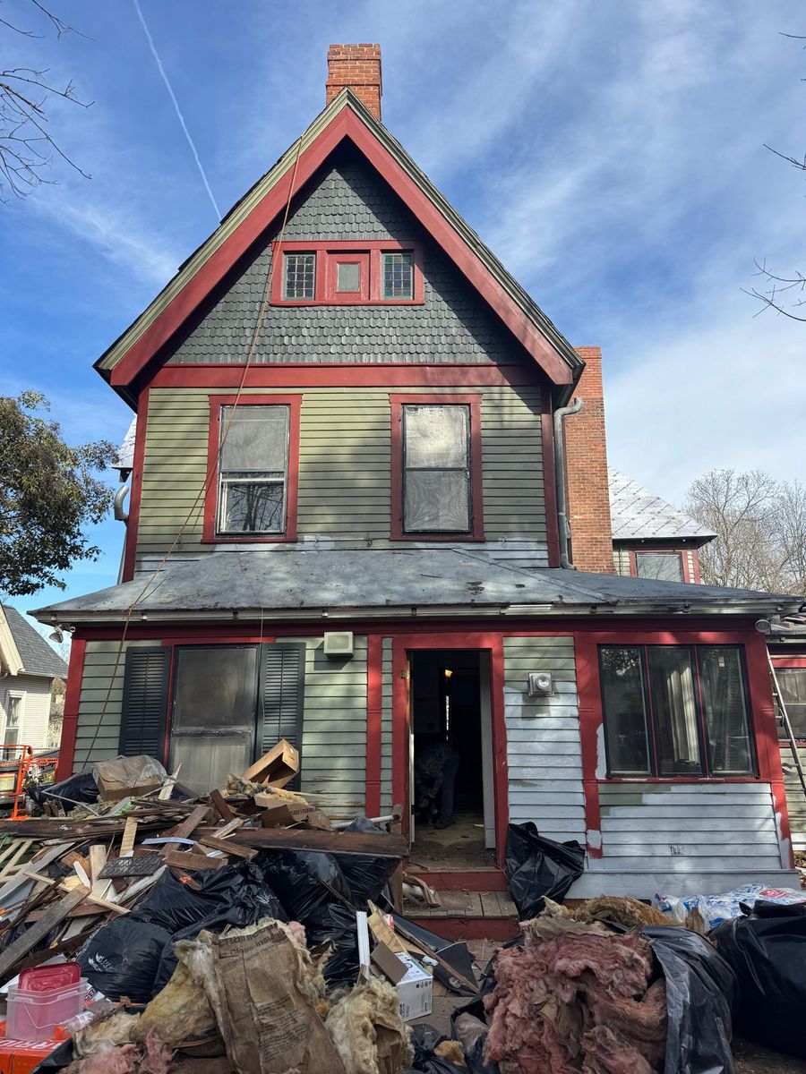 Clearing debris from the side of the house.