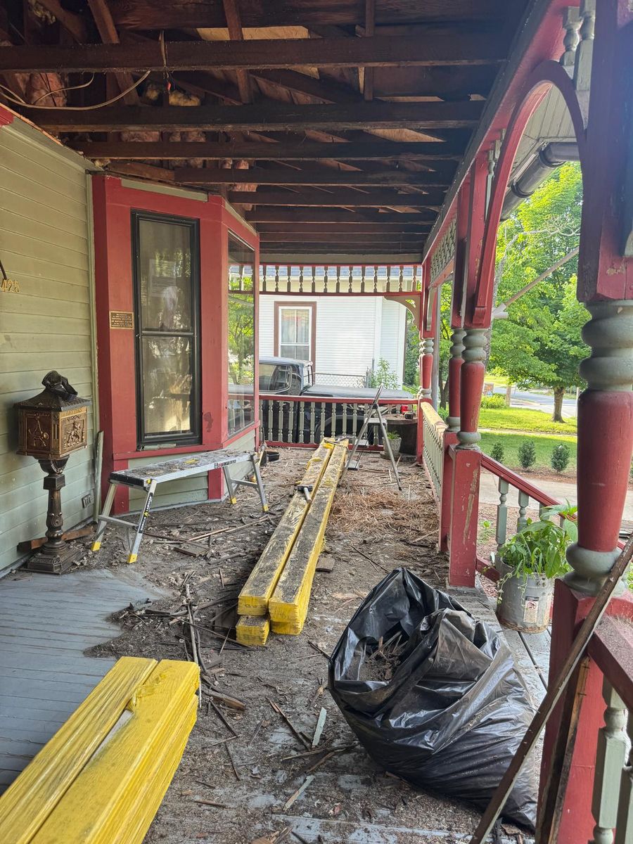 The porch filled with lumber and tools.
